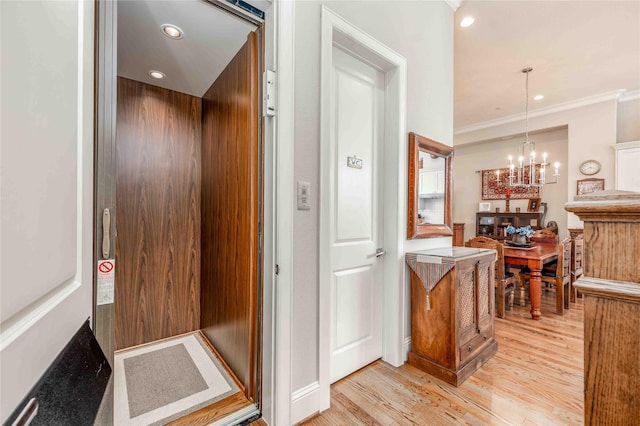 2110 Mason St, Houston, TX 77006 - corridor featuring elevator, light wood-style flooring, a chandelier, crown molding, and recessed lighting