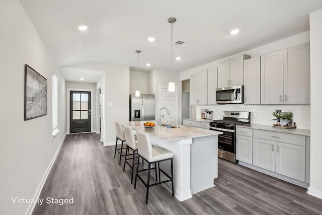 18717 Bliss Pl, New Caney, TX 77357 - kitchen featuring stainless steel appliances, a sink, dark wood-style flooring, backsplash, and recessed lighting