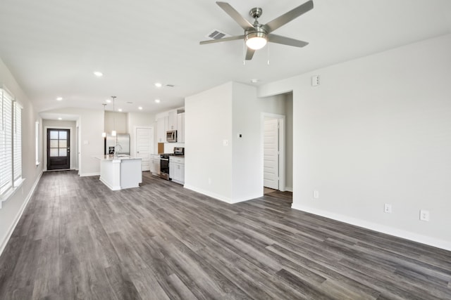 18717 Bliss Pl, New Caney, TX 77357 - unfurnished living room with dark wood-style flooring, ceiling fan, baseboards, and recessed lighting