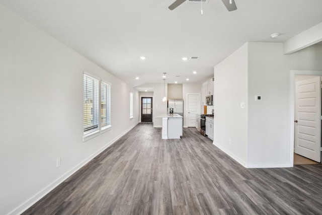 18717 Bliss Pl, New Caney, TX 77357 - unfurnished living room with dark wood finished floors, a ceiling fan, baseboards, and recessed lighting