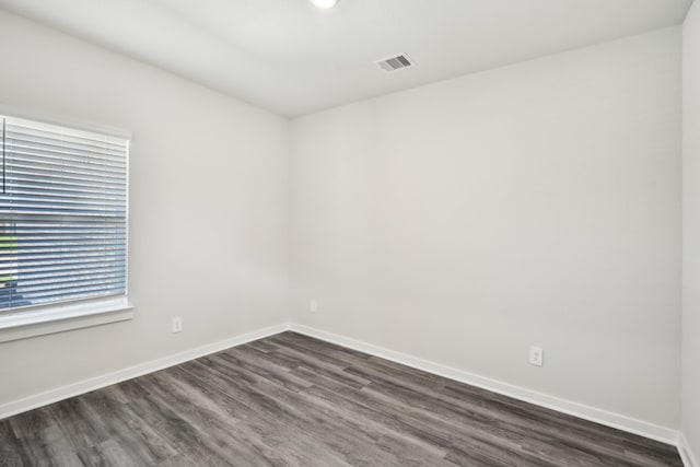 18717 Bliss Pl, New Caney, TX 77357 - spare room featuring dark wood-type flooring and baseboards