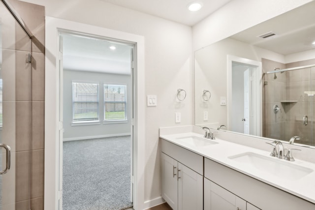 18717 Bliss Pl, New Caney, TX 77357 - full bathroom with a shower stall, double vanity, baseboards, and recessed lighting