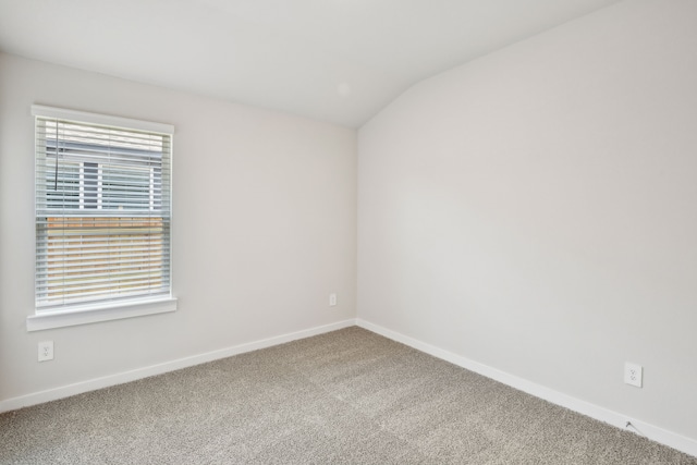 18717 Bliss Pl, New Caney, TX 77357 - spare room featuring carpet, baseboards, and lofted ceiling