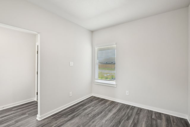 18717 Bliss Pl, New Caney, TX 77357 - unfurnished room featuring dark wood-type flooring and baseboards