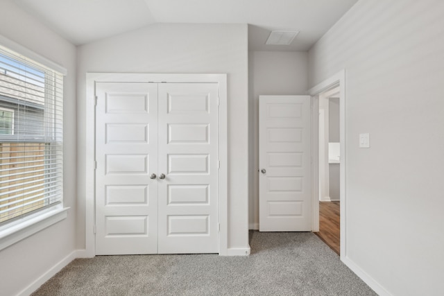 18717 Bliss Pl, New Caney, TX 77357 - unfurnished bedroom with carpet floors, a closet, baseboards, and vaulted ceiling