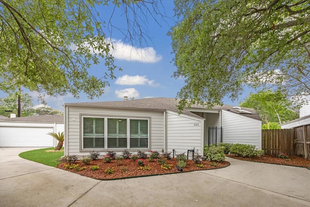 625 Rancho Bauer Dr, Houston, TX 77079 - view of side of property featuring fence, a garage, and roof with shingles