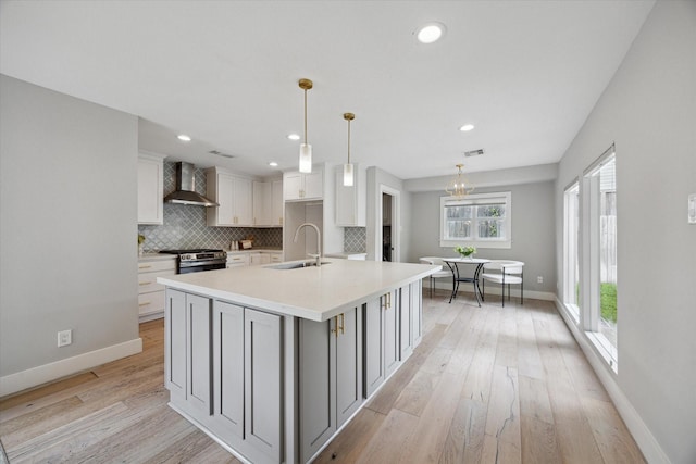 625 Rancho Bauer Dr, Houston, TX 77079 - kitchen with a sink, wall chimney exhaust hood, stainless steel gas range, tasteful backsplash, and baseboards