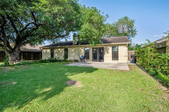 2219 Anthony Hay Ln, Katy, TX 77449 - back of property with brick siding and a patio
