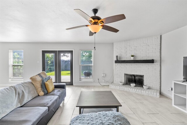 2219 Anthony Hay Ln, Katy, TX 77449 - living room with a ceiling fan, a brick fireplace, and light tile patterned floors