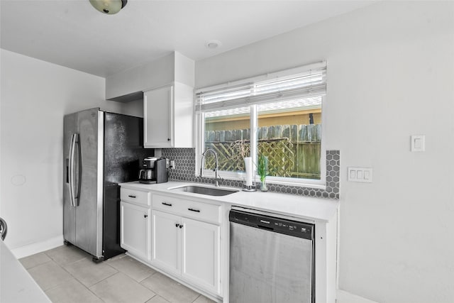 2219 Anthony Hay Ln, Katy, TX 77449 - kitchen featuring appliances with stainless steel finishes, a sink, decorative backsplash, white cabinetry, and light countertops