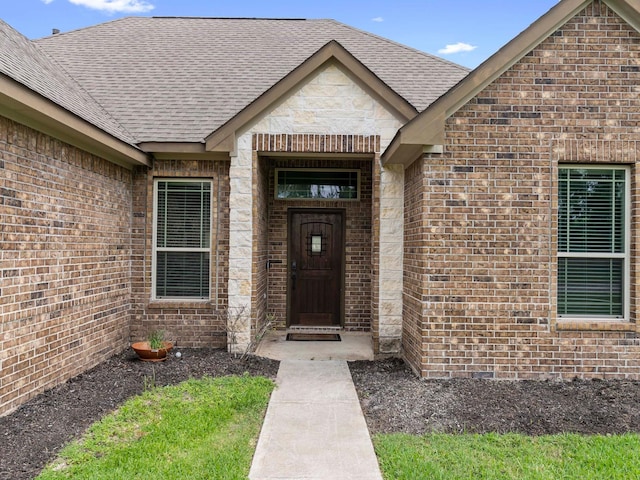 244 Mossy Meadow Dr, West Columbia, TX 77486 - doorway to property featuring brick siding and roof with shingles