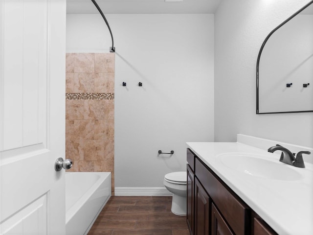 244 Mossy Meadow Dr, West Columbia, TX 77486 - bathroom featuring vanity, toilet, wood finished floors, baseboards, and  shower combination