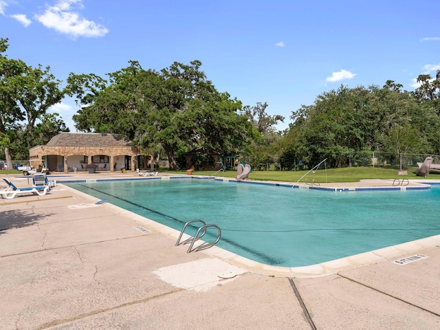 244 Mossy Meadow Dr, West Columbia, TX 77486 - community pool featuring a patio area and view of scattered trees