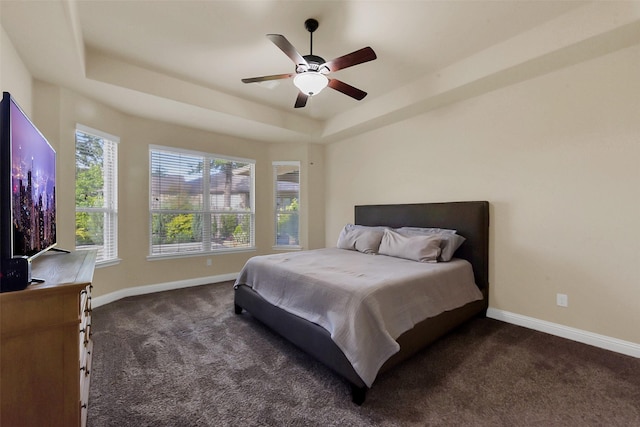 6 Muthill Cir, Conroe, TX 77304 - bedroom with dark carpet, a tray ceiling, baseboards, and ceiling fan