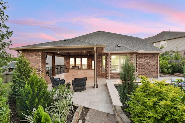 6 Muthill Cir, Conroe, TX 77304 - patio terrace at dusk with ceiling fan, fence, and outdoor lounge area