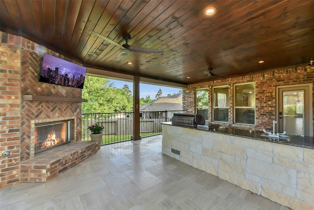 6 Muthill Cir, Conroe, TX 77304 - view of patio / terrace with an outdoor brick fireplace, exterior kitchen, fence, and a ceiling fan