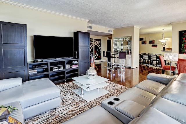 3350 Mccue Rd Unit 702, Houston, TX 77056 - living area featuring ornamental molding, wood finished floors, and a textured ceiling
