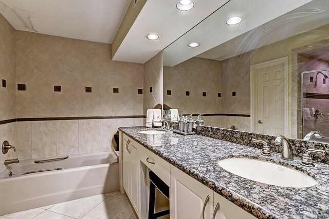 3350 Mccue Rd Unit 702, Houston, TX 77056 - full bathroom with tile patterned floors, tile walls, a tub to relax in, a shower, and double vanity