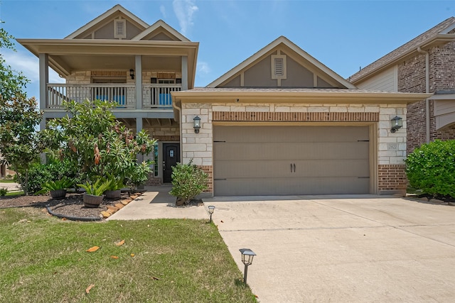 2822 Bluesage Bluff Dr, Richmond, TX 77406 - view of front facade with brick siding, driveway, an attached garage, a balcony, and stone siding