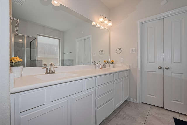2822 Bluesage Bluff Dr, Richmond, TX 77406 - full bathroom with tile patterned floors, double vanity, and a shower with shower door