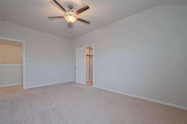 2822 Bluesage Bluff Dr, Richmond, TX 77406 - unfurnished bedroom with a walk in closet, light carpet, baseboards, lofted ceiling, and ceiling fan
