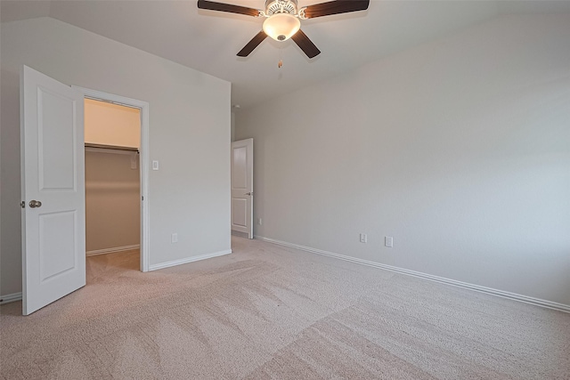 2822 Bluesage Bluff Dr, Richmond, TX 77406 - unfurnished bedroom with a spacious closet, light carpet, baseboards, lofted ceiling, and a ceiling fan