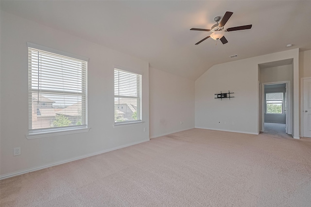 2822 Bluesage Bluff Dr, Richmond, TX 77406 - empty room with vaulted ceiling, a ceiling fan, light carpet, and baseboards