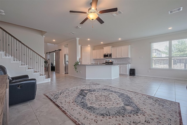 2822 Bluesage Bluff Dr, Richmond, TX 77406 - living room with a barn door, light tile patterned flooring, a ceiling fan, crown molding, and recessed lighting
