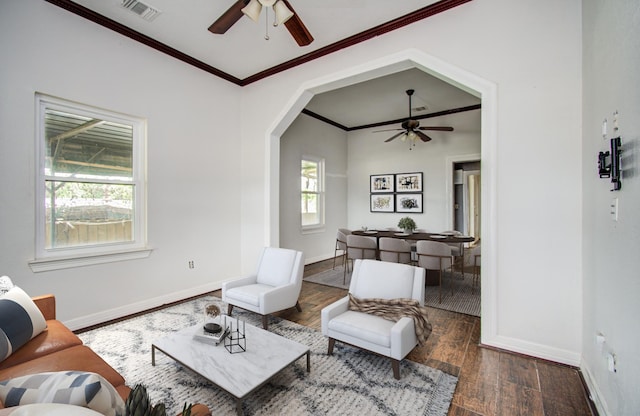 2711 Maury St, Houston, TX 77009 - living area with ceiling fan, wood finished floors, baseboards, ornamental molding, and arched walkways