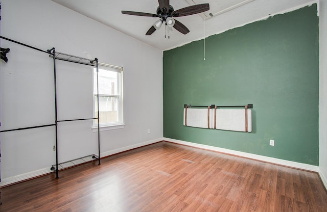 2711 Maury St, Houston, TX 77009 - unfurnished room featuring wood finished floors, a ceiling fan, baseboards, and attic access