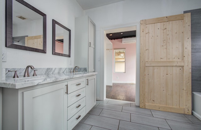 2711 Maury St, Houston, TX 77009 - bathroom with an AC wall unit, double vanity, and a bathtub