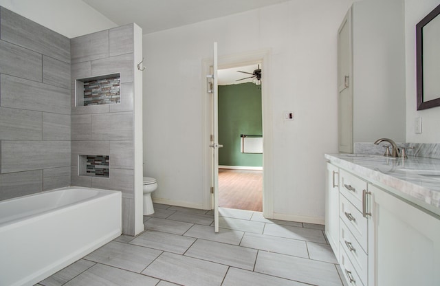 2711 Maury St, Houston, TX 77009 - bathroom with toilet, vanity, ceiling fan, a tub, and a fireplace