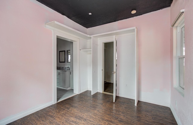 2711 Maury St, Houston, TX 77009 - unfurnished bedroom featuring wood finished floors, baseboards, and connected bathroom