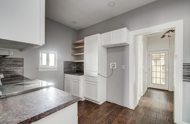 2711 Maury St, Houston, TX 77009 - kitchen featuring open shelves, dark wood-type flooring, white cabinetry, tasteful backsplash, and dark countertops