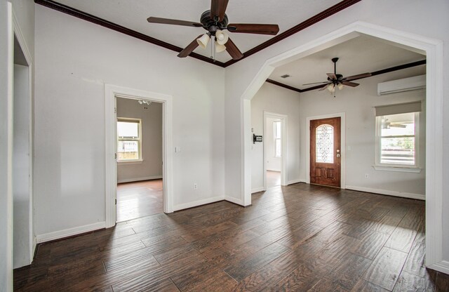 2711 Maury St, Houston, TX 77009 - entrance foyer with a ceiling fan, wood finished floors, crown molding, baseboards, and arched walkways