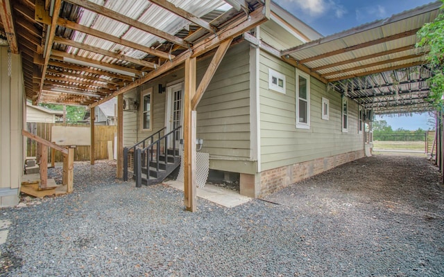 2711 Maury St, Houston, TX 77009 - view of home's exterior featuring entry steps, fence, and a carport
