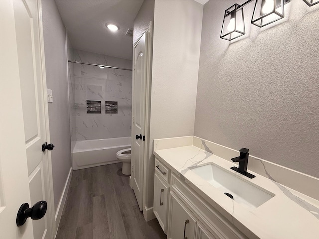 23711 Saxon Way, Hockley, TX 77447 - full bathroom with vanity, toilet, wood finished floors, tub / shower combination, and baseboards