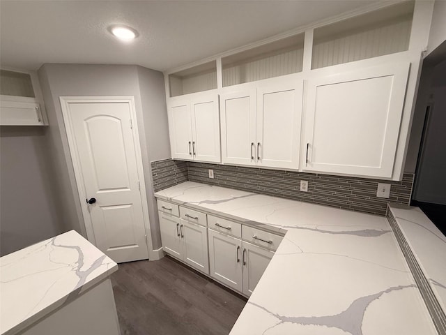 23711 Saxon Way, Hockley, TX 77447 - kitchen featuring backsplash, dark wood-style flooring, white cabinets, and light stone countertops