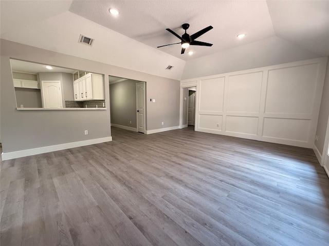 23711 Saxon Way, Hockley, TX 77447 - unfurnished living room with ceiling fan, lofted ceiling, dark wood-type flooring, baseboards, and recessed lighting