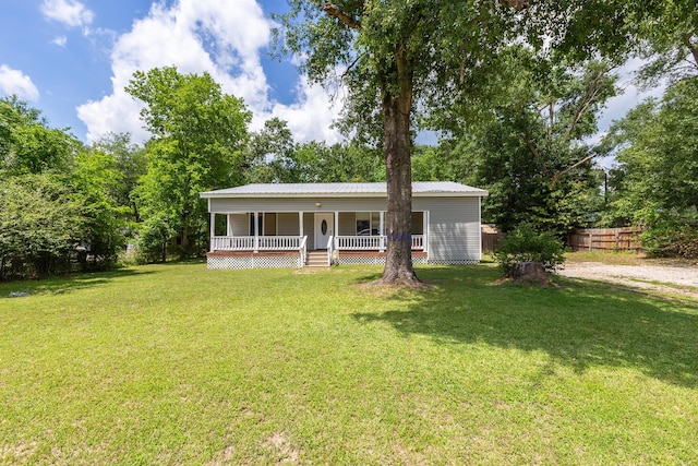 240 7th St, Trinity, TX 75862 - view of front facade with covered porch and metal roof