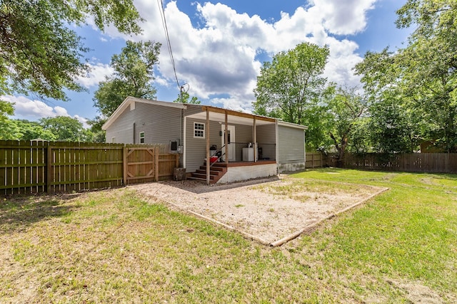 240 7th St, Trinity, TX 75862 - rear view of house featuring a deck and a gate