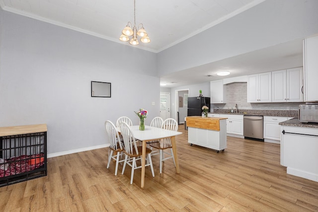 240 7th St, Trinity, TX 75862 - dining space with ornamental molding, light wood-type flooring, baseboards, and a chandelier