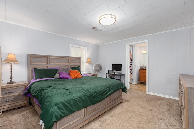 240 7th St, Trinity, TX 75862 - bedroom featuring light carpet, baseboards, and ensuite bath