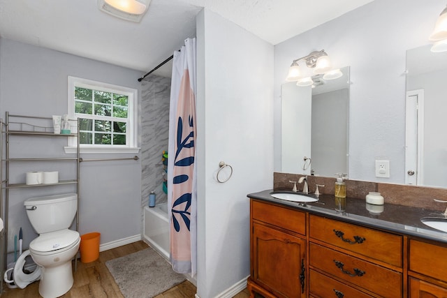 240 7th St, Trinity, TX 75862 - full bathroom featuring wood finished floors, toilet, double vanity, and shower / bath combo with shower curtain