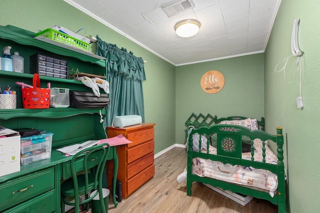 240 7th St, Trinity, TX 75862 - bedroom with ornamental molding, wood finished floors, and an office area