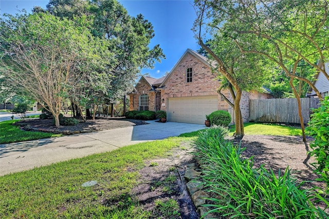 view of front of house with brick siding, fence, concrete driveway, and an attached garage