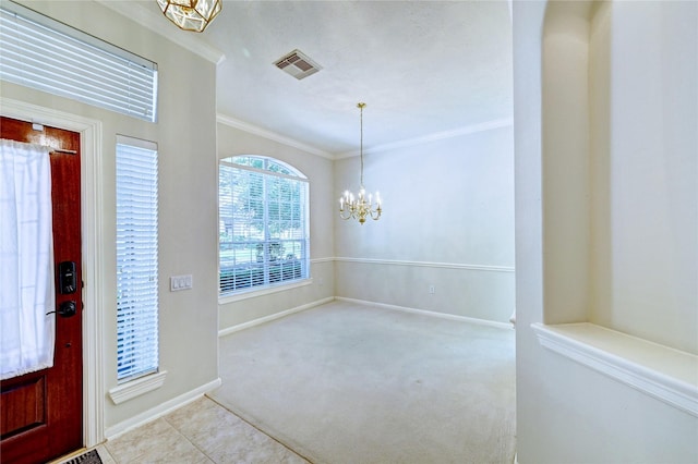 carpeted entryway with a chandelier, crown molding, and baseboards