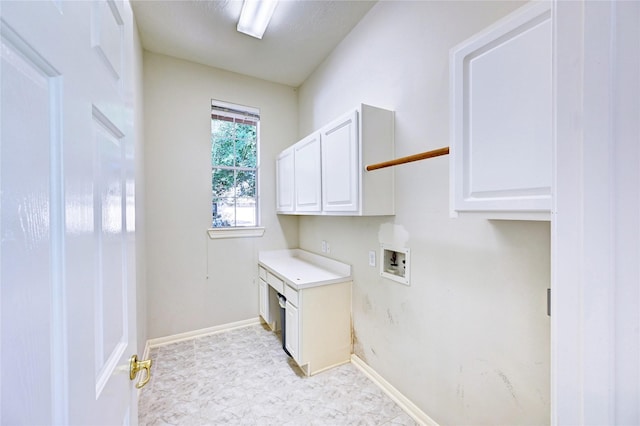 laundry room featuring cabinet space, washer hookup, and baseboards