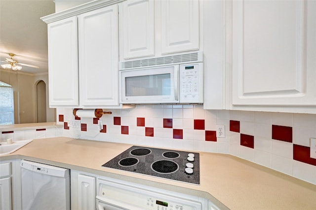 kitchen with white microwave, dishwashing machine, black electric cooktop, oven, and tasteful backsplash