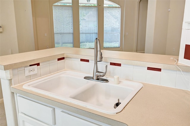kitchen view of a sink and light countertops
